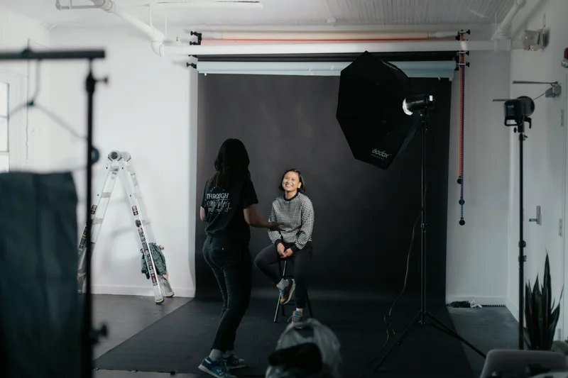 A camera on a tripod in a photography studio.